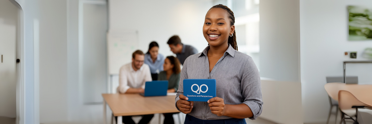 Lady in a happy team meeting holding the Q&P Cards from KimUnity Soulutions.